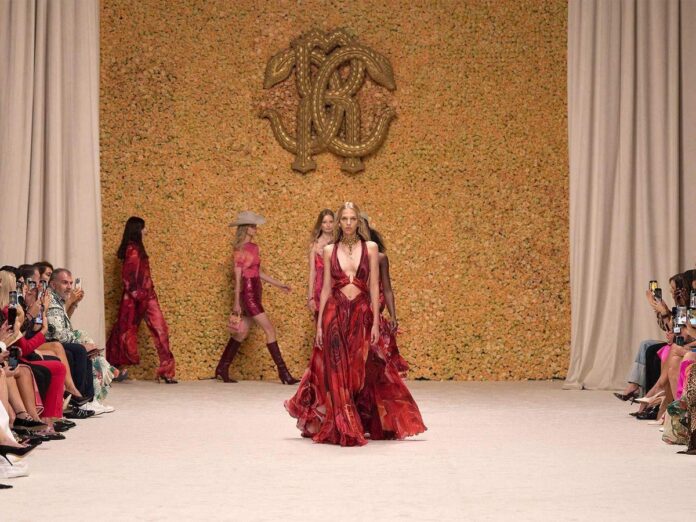 Model wearing a vibrant design against a floral background, showcasing the latest trends in fashion.
